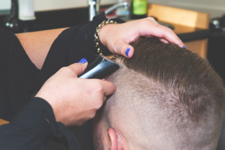 Barber giving customer clipper cut